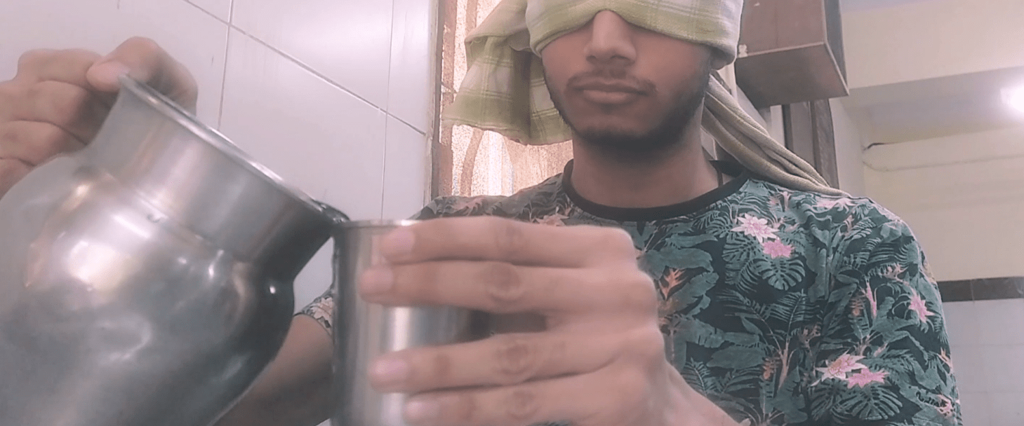 A picture of me with a blindfold pouring water from a jug